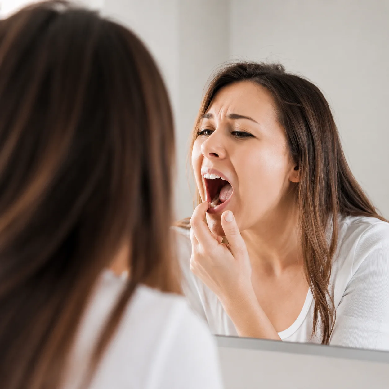 Dentist at Arasu Dental Care, Coimbatore, examining a patient to diagnose a dental problem