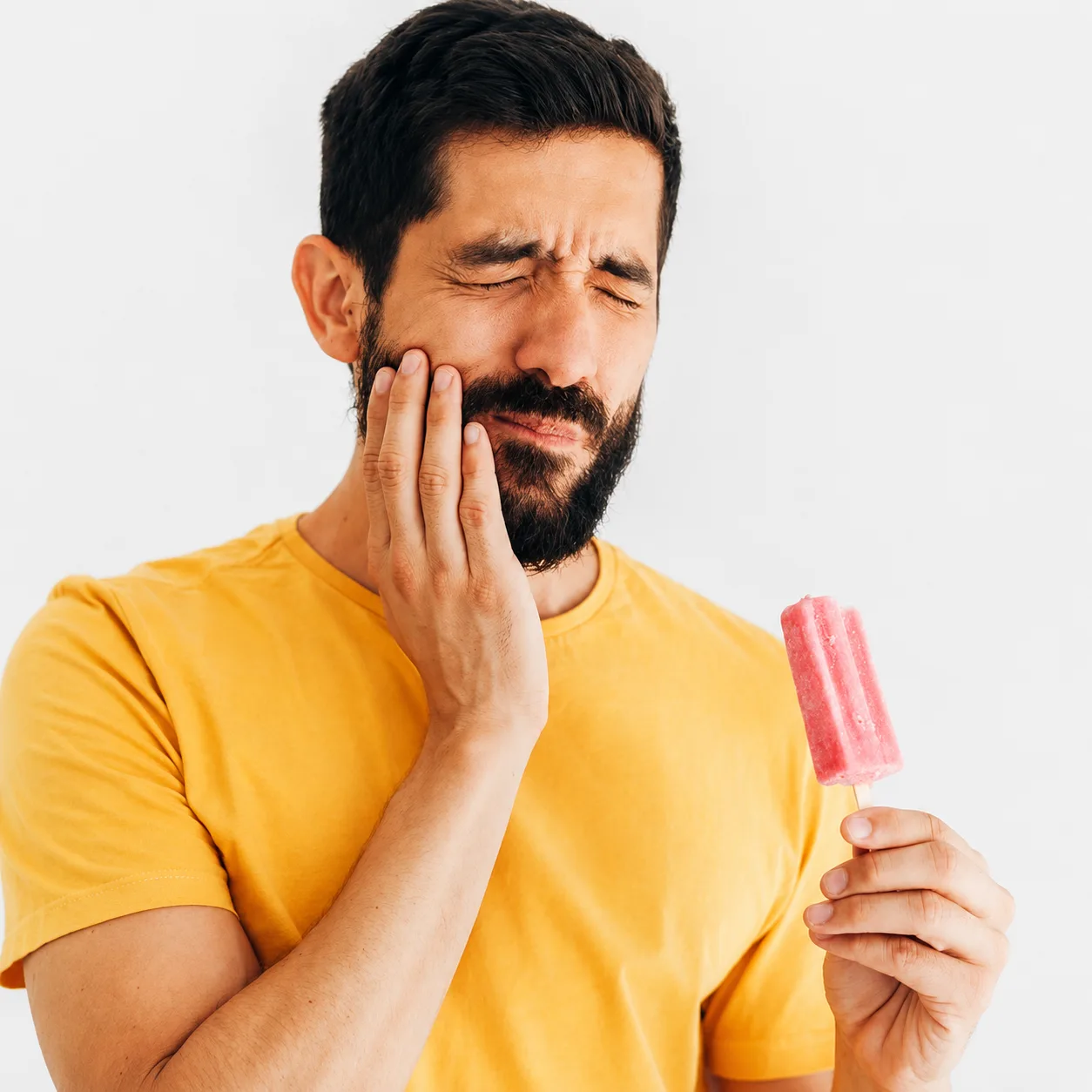 Dentist at Arasu Dental Care, Coimbatore, examining a patient with sensitive teeth to find the cause